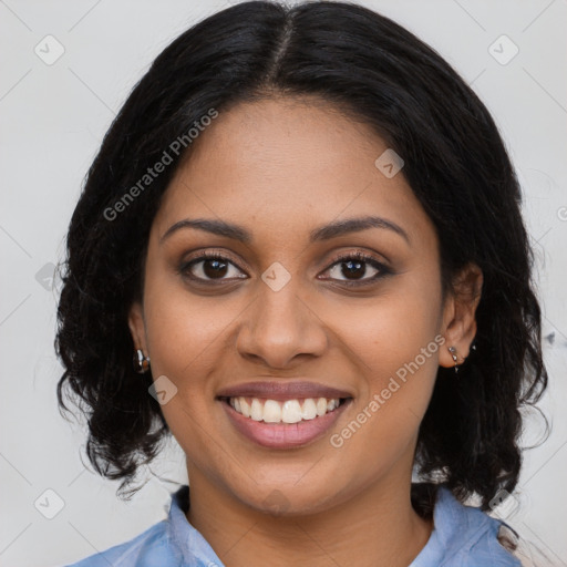 Joyful black young-adult female with long  black hair and brown eyes