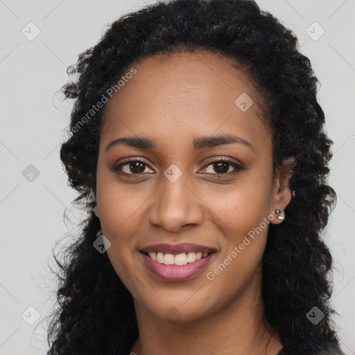 Joyful black young-adult female with long  black hair and brown eyes