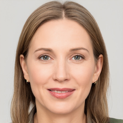 Joyful white adult female with long  brown hair and grey eyes