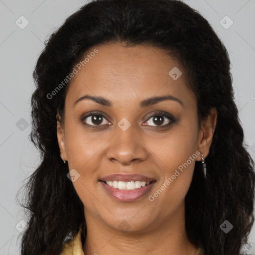 Joyful black young-adult female with long  brown hair and brown eyes