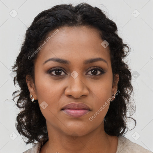 Joyful black young-adult female with long  brown hair and brown eyes