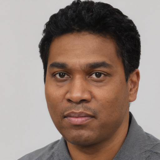 Neutral black young-adult male with short  black hair and brown eyes
