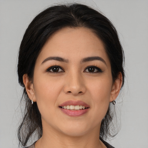 Joyful latino young-adult female with medium  black hair and brown eyes
