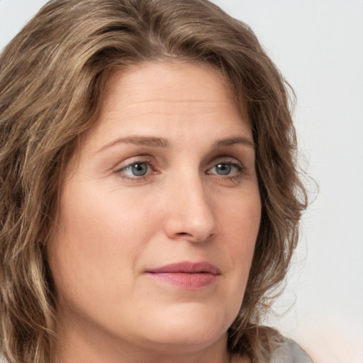 Joyful white young-adult female with long  brown hair and green eyes