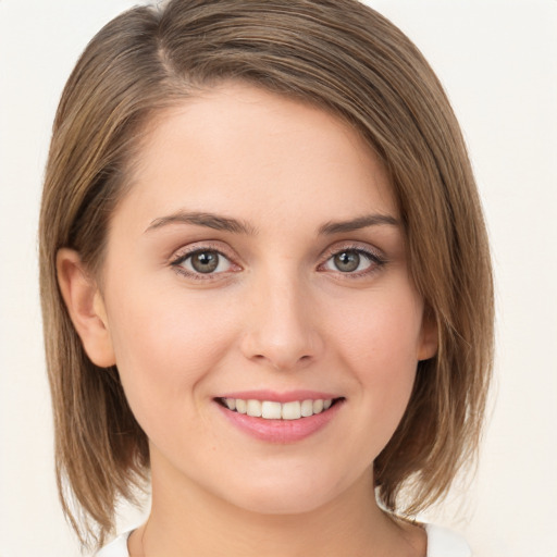 Joyful white young-adult female with medium  brown hair and green eyes