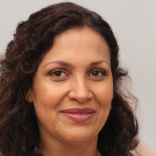Joyful latino adult female with medium  brown hair and brown eyes