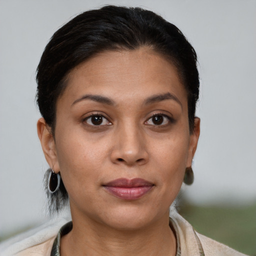 Joyful latino young-adult female with short  brown hair and brown eyes