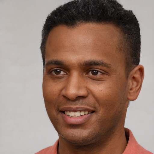 Joyful latino young-adult male with short  brown hair and brown eyes