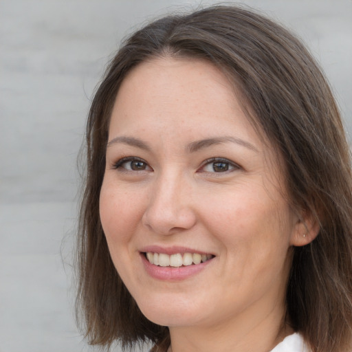 Joyful white adult female with medium  brown hair and brown eyes