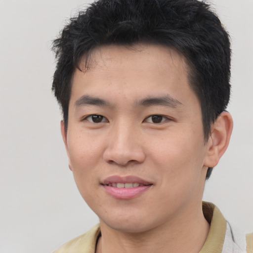 Joyful asian young-adult male with short  brown hair and brown eyes