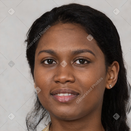 Joyful black young-adult female with long  black hair and brown eyes