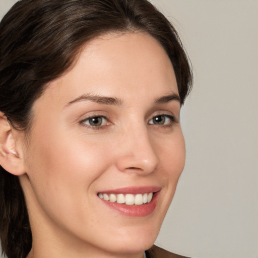 Joyful white young-adult female with medium  brown hair and brown eyes