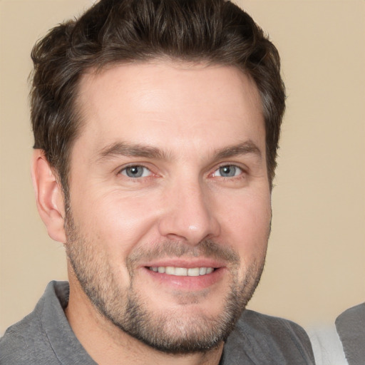 Joyful white adult male with short  brown hair and brown eyes