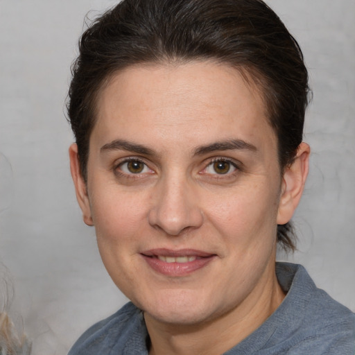 Joyful white adult female with medium  brown hair and brown eyes