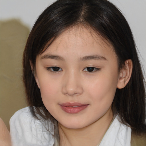 Joyful asian child female with medium  brown hair and brown eyes