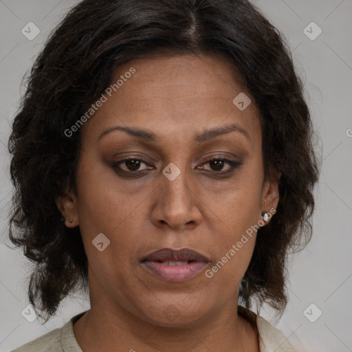 Joyful black adult female with medium  brown hair and brown eyes