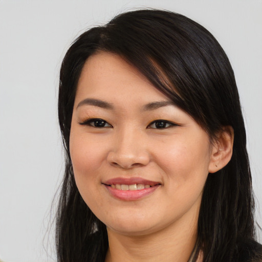 Joyful asian young-adult female with long  black hair and brown eyes