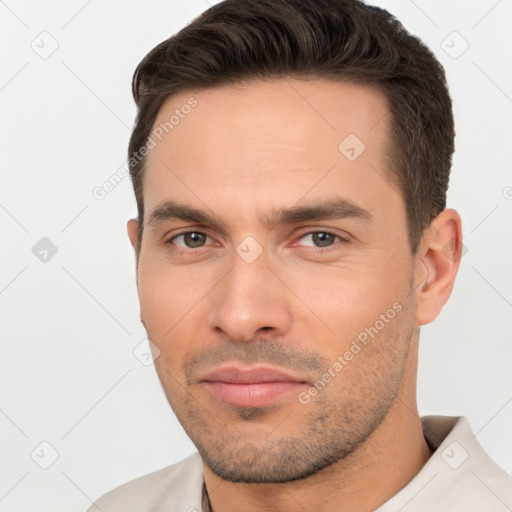 Joyful white young-adult male with short  brown hair and brown eyes