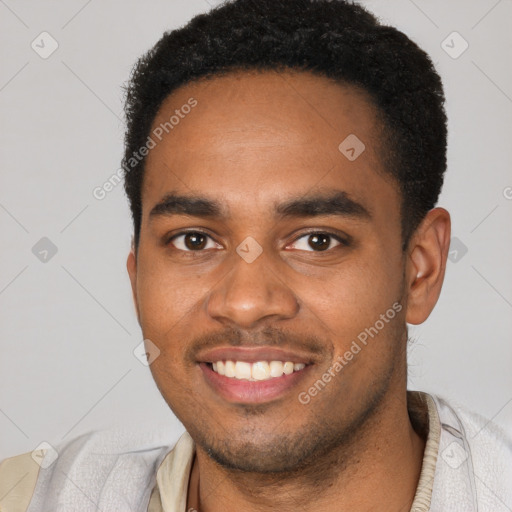 Joyful black young-adult male with short  brown hair and brown eyes