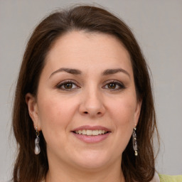 Joyful white young-adult female with long  brown hair and grey eyes