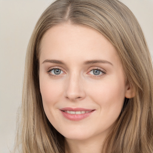 Joyful white young-adult female with long  brown hair and grey eyes