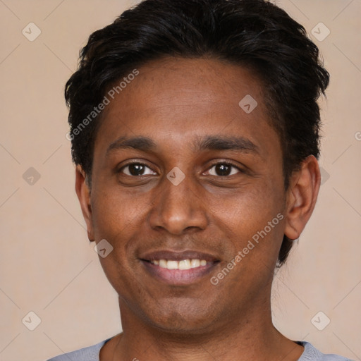 Joyful black young-adult male with short  black hair and brown eyes