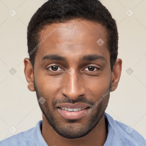 Joyful black young-adult male with short  brown hair and brown eyes