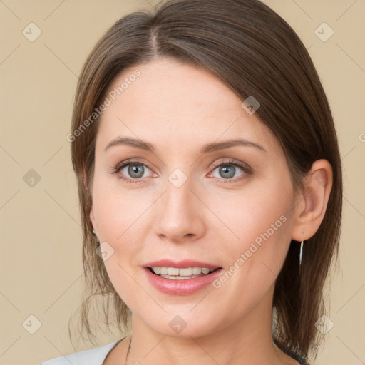 Joyful white young-adult female with medium  brown hair and green eyes