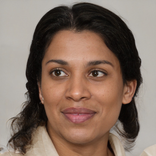 Joyful asian adult female with medium  brown hair and brown eyes