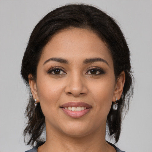 Joyful latino young-adult female with medium  brown hair and brown eyes