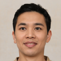 Joyful asian young-adult male with short  black hair and brown eyes