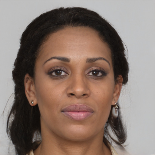 Joyful black young-adult female with long  brown hair and brown eyes