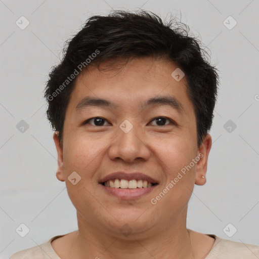 Joyful asian adult male with short  brown hair and brown eyes