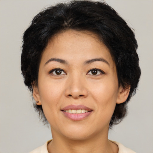 Joyful asian adult female with medium  brown hair and brown eyes