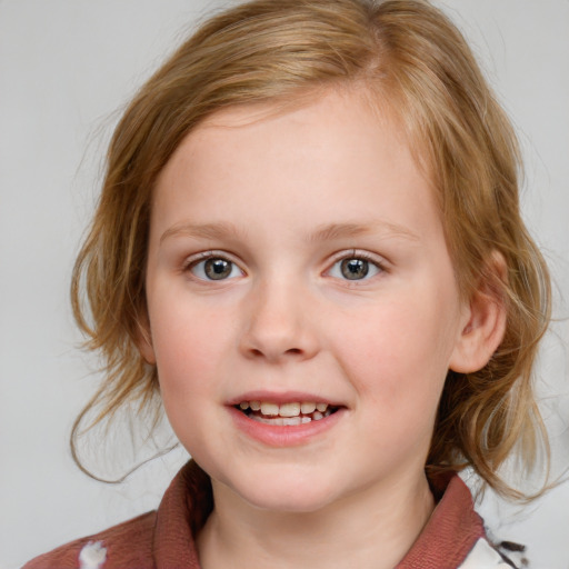 Joyful white child female with medium  brown hair and blue eyes