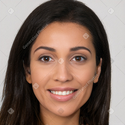 Joyful latino young-adult female with long  brown hair and brown eyes