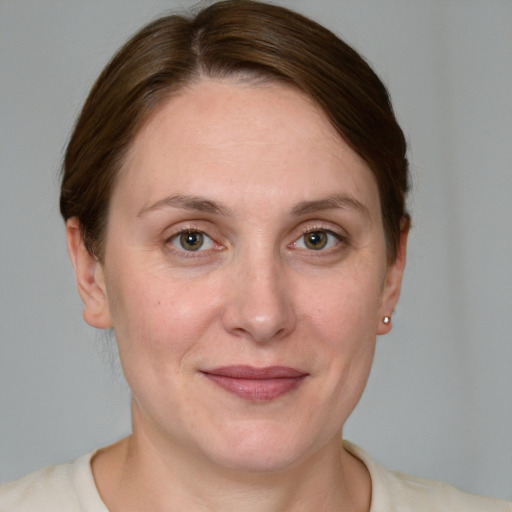 Joyful white adult female with medium  brown hair and grey eyes