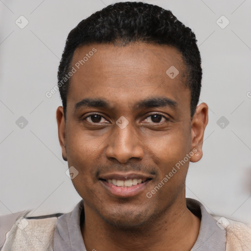 Joyful black young-adult male with short  black hair and brown eyes