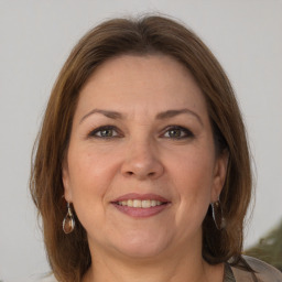 Joyful white adult female with medium  brown hair and grey eyes