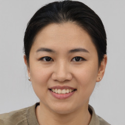 Joyful asian young-adult female with medium  brown hair and brown eyes