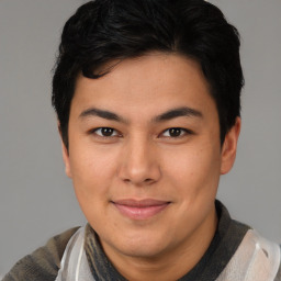 Joyful asian young-adult male with short  brown hair and brown eyes