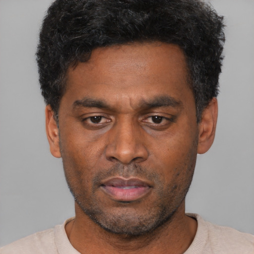 Neutral black adult male with short  black hair and brown eyes