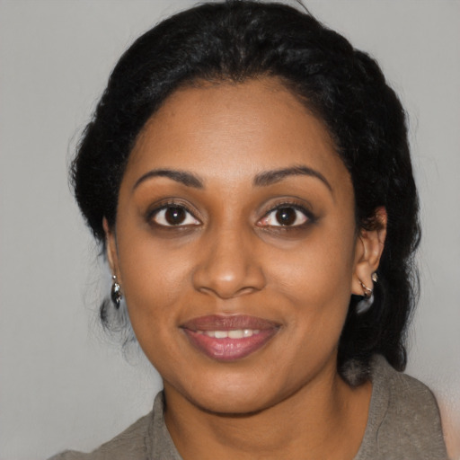 Joyful black young-adult female with medium  black hair and brown eyes
