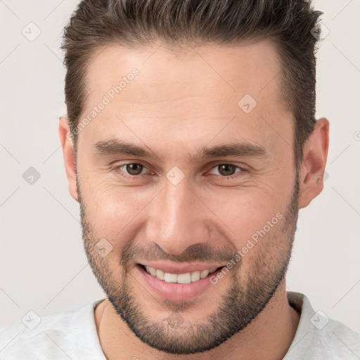 Joyful white young-adult male with short  brown hair and brown eyes