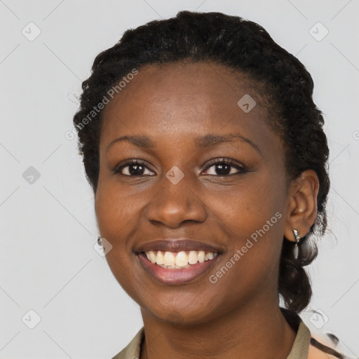 Joyful black young-adult female with short  brown hair and brown eyes