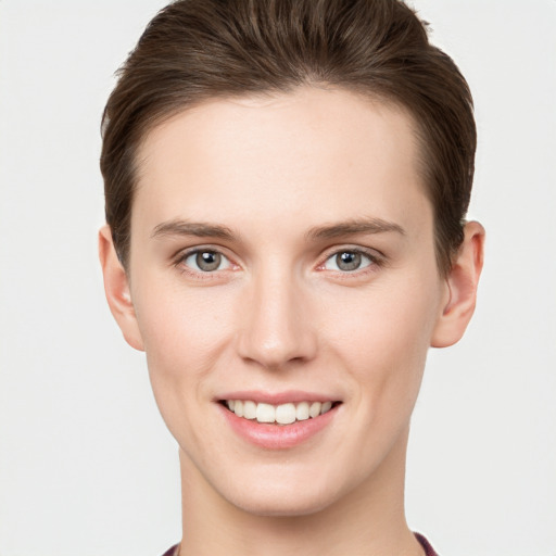 Joyful white young-adult female with short  brown hair and grey eyes