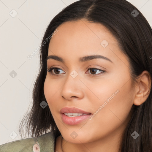 Joyful latino young-adult female with long  brown hair and brown eyes