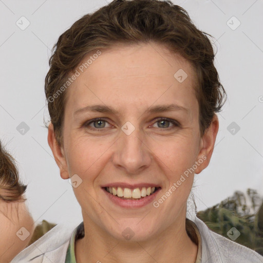 Joyful white adult female with short  brown hair and grey eyes