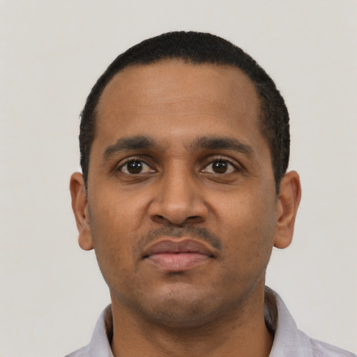 Neutral black young-adult male with short  black hair and brown eyes