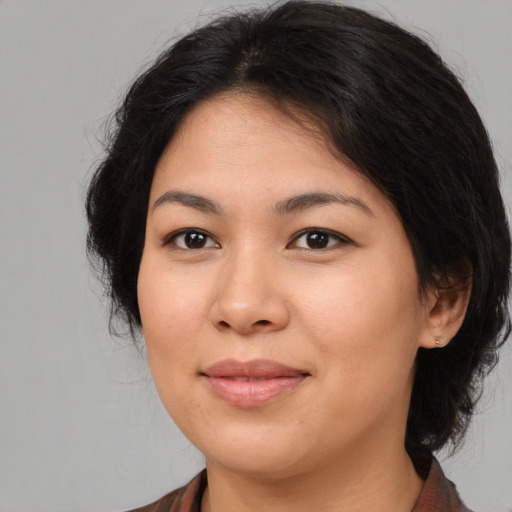 Joyful asian young-adult female with medium  brown hair and brown eyes